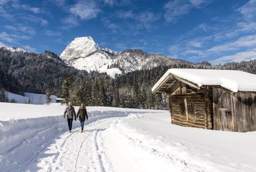 Winter hikers in front of  Wilder Kaiser - St. Johann in Tirol region