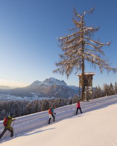 Snow-shoe hiking at dusk - St. Johann in Tirol region