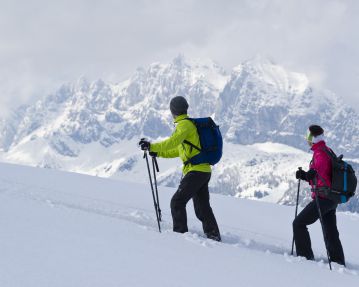Snow-shoe hiker in front of the Wilder Kaiser - St. Johann in Tirol region