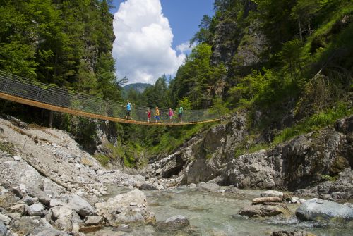Family at the Griesbachklamm gorge suspension bridge - St. Johann in Tirol region