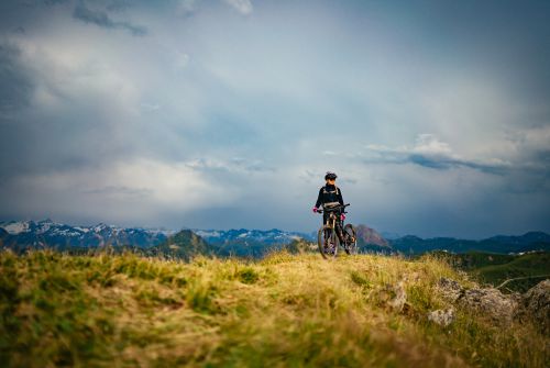 Kitzbühel-Alps-bike-hero-Lena-Koller-on-a-ridge-with-her-mountain-bike-in-the-Brixental-Valley-c-Daniel-Gollner