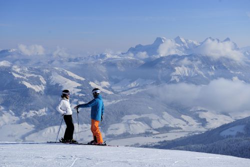Skiers in front of the panoramic view - St. Johann in Tirol region